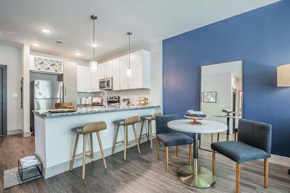 A kitchen with blue walls and a white counter.