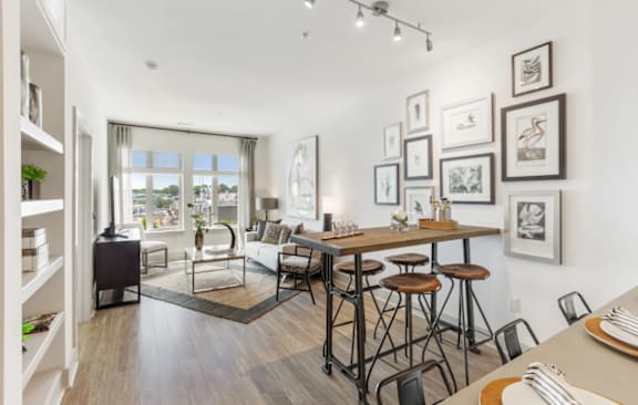 A modern kitchen with a dining table and chairs.