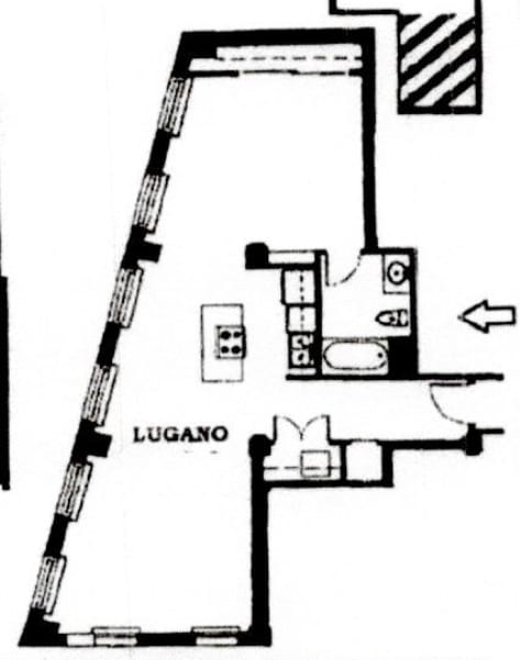 A black and white drawing of a floor plan with the word "LUGANO" on it.