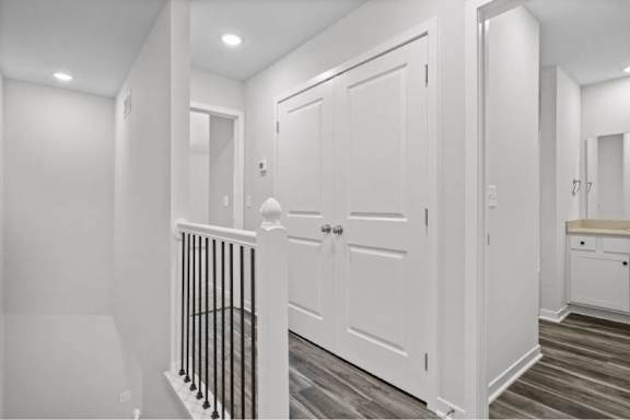 A white door is in the middle of a hallway.