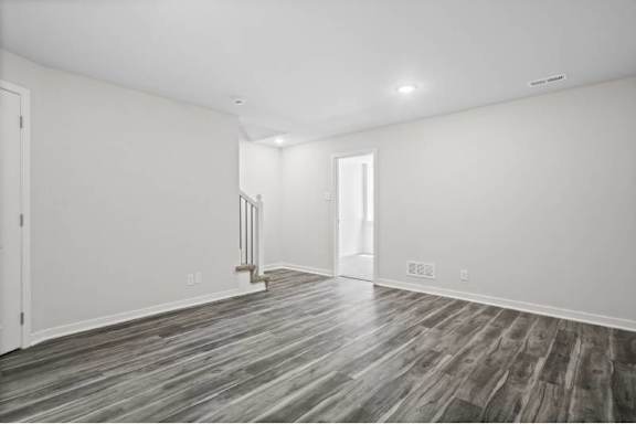 A room with a wooden floor and white walls.