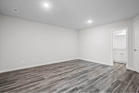 A room with a wooden floor and white walls.