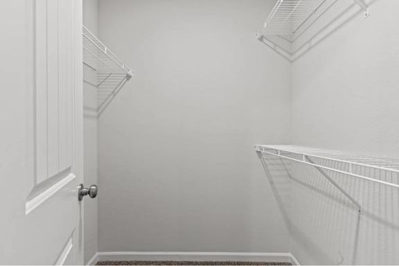 A white door with a handle is on the left and a white shelf is on the right.