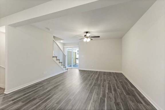 A room with a wooden floor and a ceiling fan.