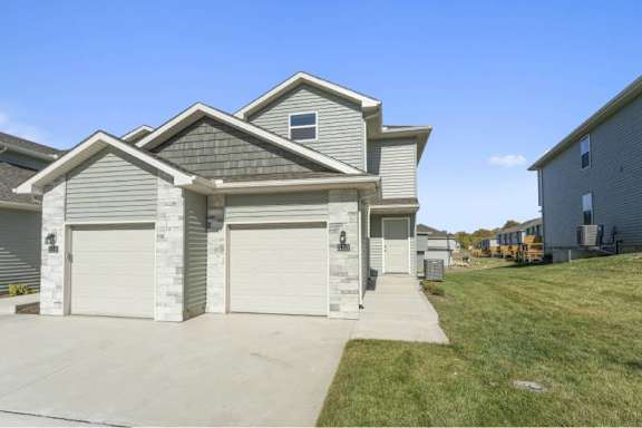 A two-story house with a garage is shown in the image.