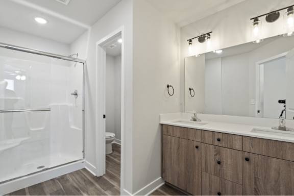 A bathroom with a white sink and a mirror above it.