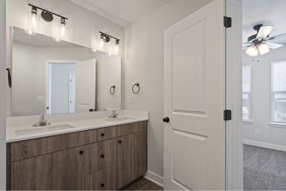 A bathroom with a vanity and a mirror.