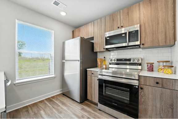 A kitchen with wooden cabinets and stainless steel appliances.