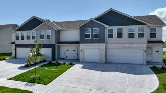 A modern two-story house with a garage and a driveway.