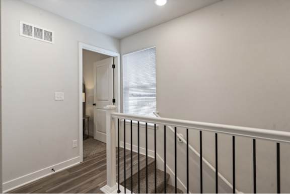 A room with a white door and a window with blinds.