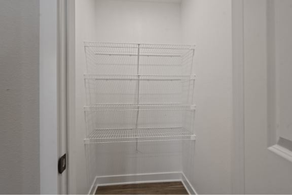 Empty white shelves in a white room.