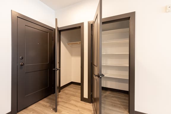 a bedroom with a medium sized wardrobe and a large mirror