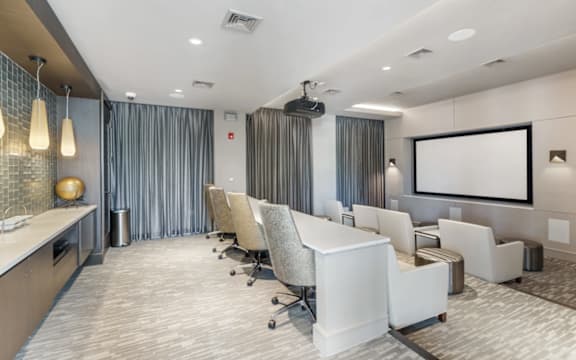 A conference room with a long table and chairs.