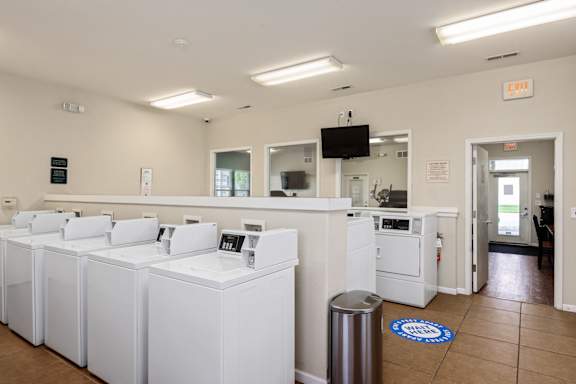 A laundromat with rows of washers and dryers.