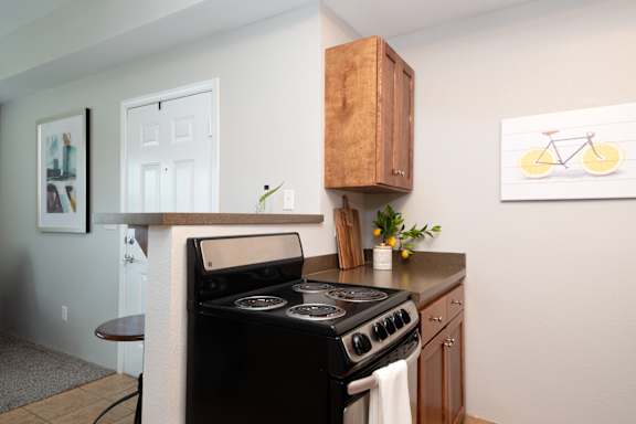 A black stove top oven with a white towel on it.