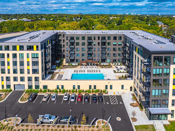 A large building with a pool in the middle of a parking lot.