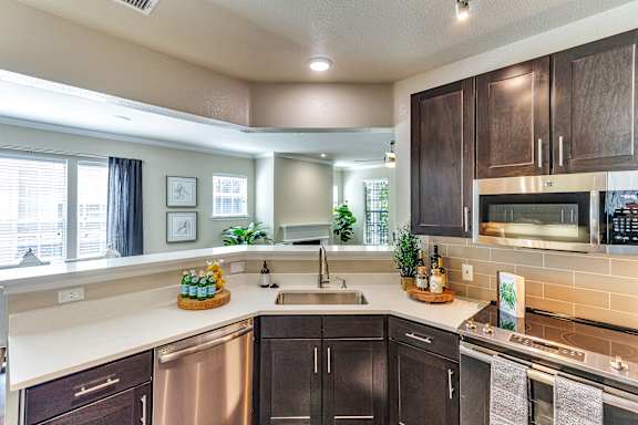 a kitchen with wooden cabinets and a sink
