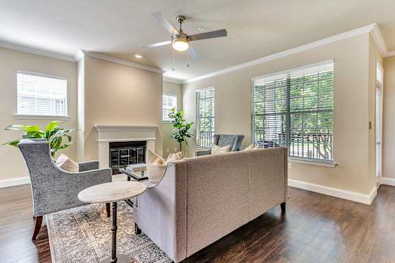 a living room with a couch and a ceiling fan