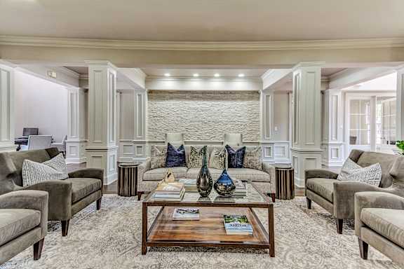 a living room with couches and chairs and a coffee table