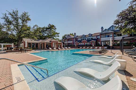 our apartments have a large swimming pool with chaise lounge chairs