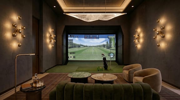 A room with a large screen and a person playing golf.