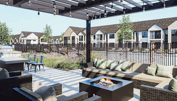 A patio with a fire pit and seating area.