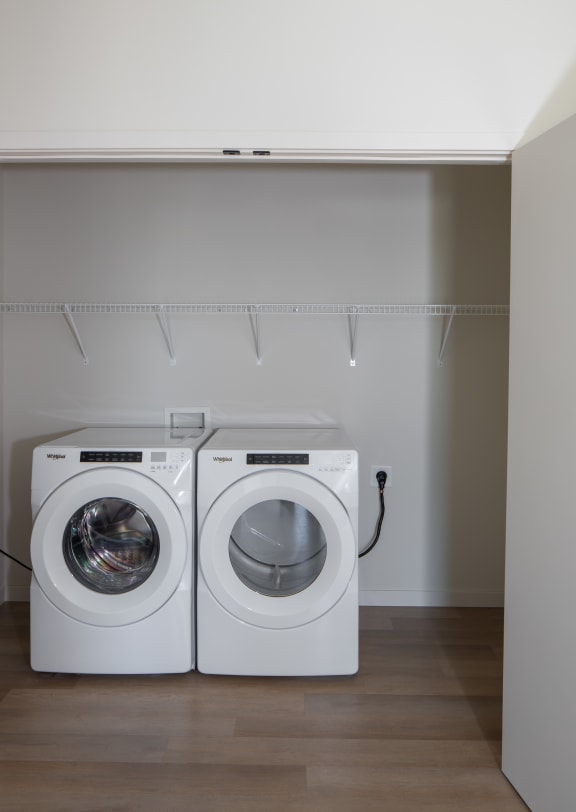 a washer and dryer in a laundry room at Riverhouse Apartments, Fargo, North Dakota 58102