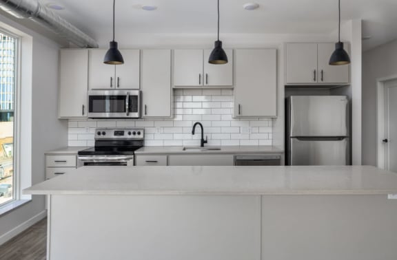 Fully Equipped Kitchen with White Cabinetry and Stainless-Steel Efficient Appliances at Kesler Apartments in Downtown Fargo, Fargo, North Dakota 58102