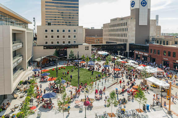 A large open plaza with people sitting and walking around at Kesler Apartments in Downtown Fargo, Fargo, North Dakota 58102