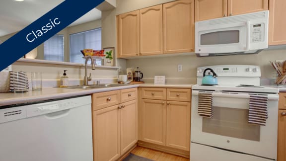 a kitchen with white appliances and wooden cabinets