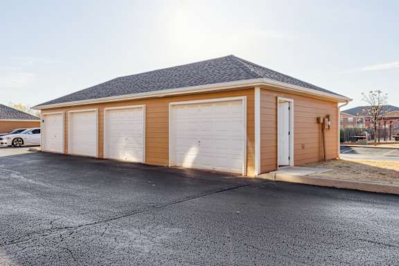 A two-car garage with a brown exterior and white doors.