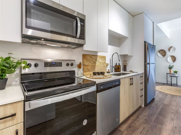 a kitchen with a stove top oven next to a sink