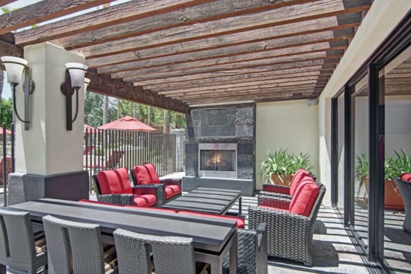 a patio with a fireplace and a pergola