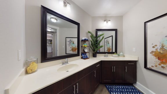 the preserve at ballantyne commons community bathroom with double sinks and a large mirror