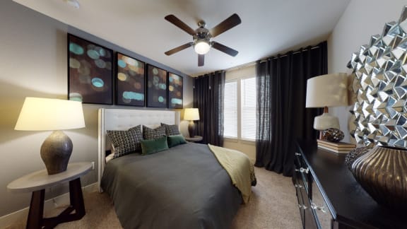 a bedroom with a bed and a ceiling fan