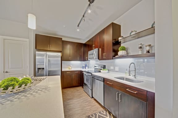 a modern kitchen with stainless steel appliances and wooden cabinets