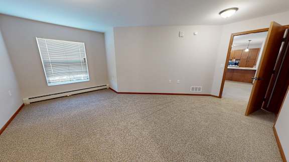 A room with a window and a door.