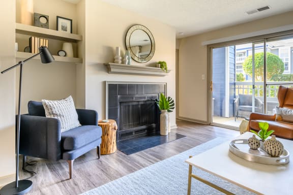 a living room with a fireplace and a sliding glass door