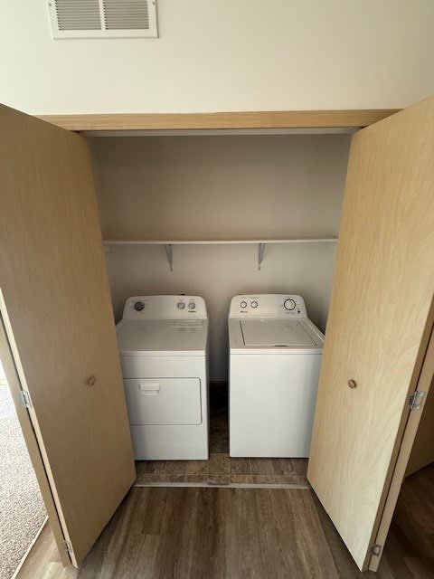 A small laundry room with a washer and dryer in it.