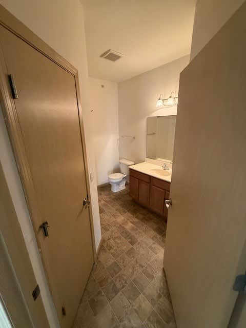A bathroom with a toilet and sink.