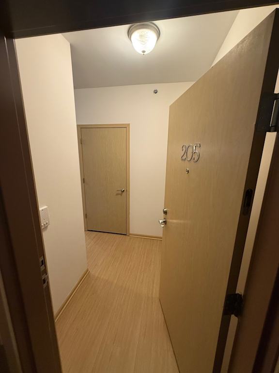 A hallway with a door numbered 205.