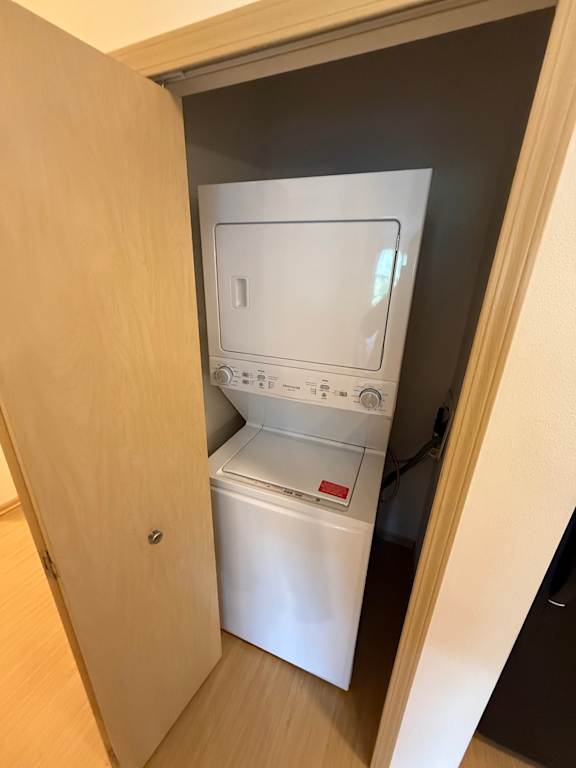 A white dishwasher is built into a cabinet in a kitchen.