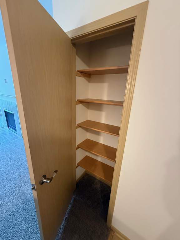 A wooden door with a shelf underneath it.