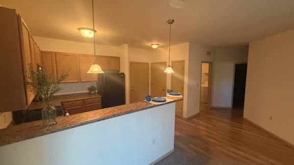 A kitchen with wooden cabinets and a white countertop.