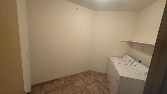 A small laundry room with a washer and dryer.