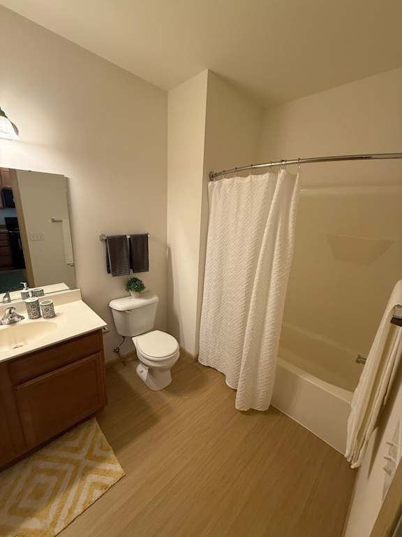 A bathroom with a toilet, sink, and shower.