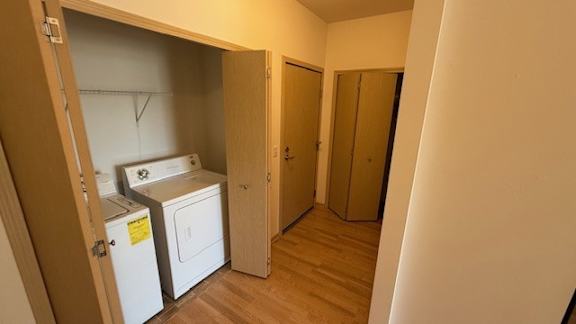 A small laundry room with a washer and dryer.