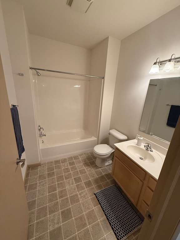 A bathroom with a toilet, sink, and bathtub.