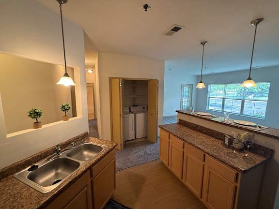 A kitchen with a sink and a window.