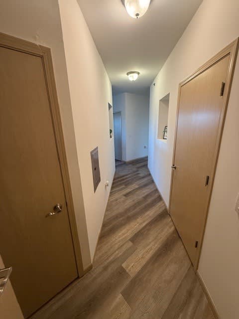 A long hallway with doors on both sides.